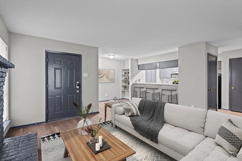 A modern living room with a grey couch and a wooden coffee table.